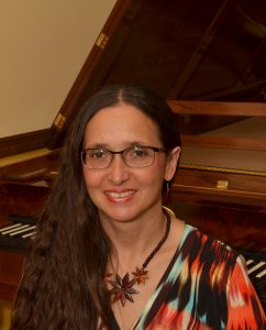 The Art of Piano Instructor Dr. Maria Horváth at Her Five-octave Viennese Fortepiano Instructor Dr. Horváth sitting in front of her fortepiano