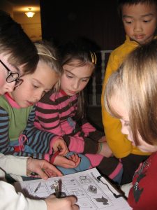 A group of students are immersed in a music game at a Performance Party