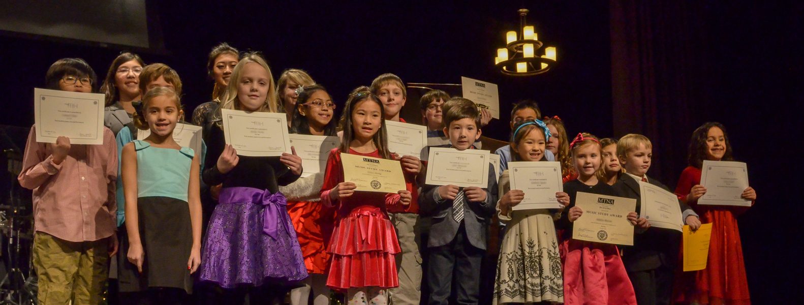 Over twenty The Art of Piano students line up with their certificates after the 2014 Winter recital