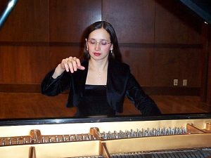 Instructor Maria during a performance on a modern grand piano